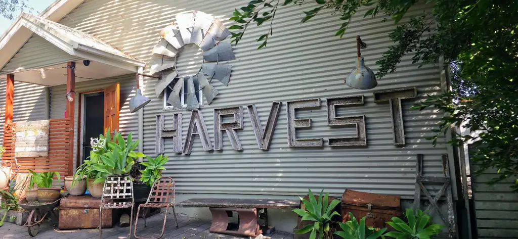 Harvest Milton exterior with rustic timber signage